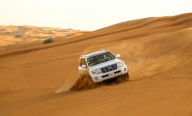 white suv on brown sand
