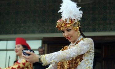 a woman in a white and gold costume